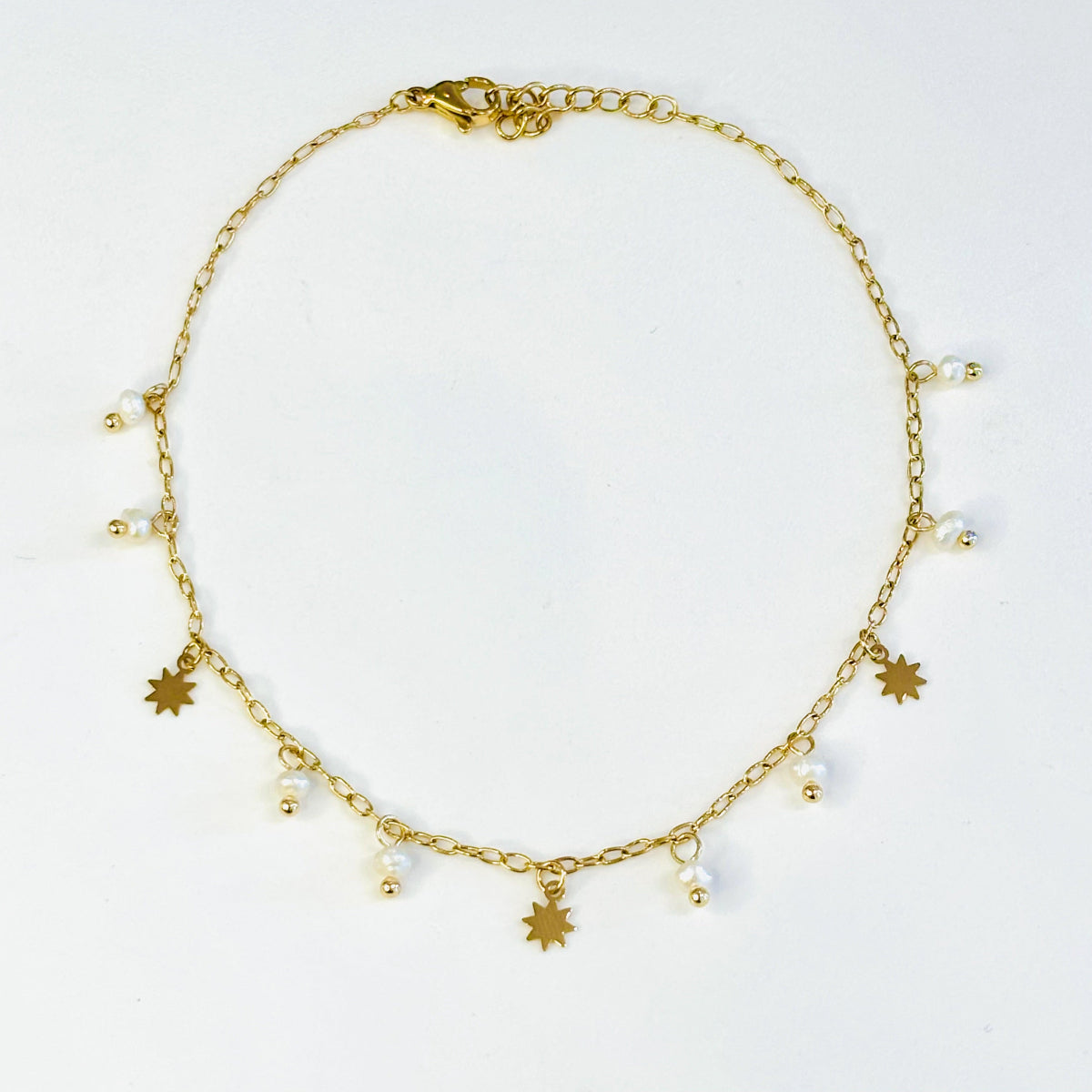 Bracelet de cheville acier inoxydable doré et pampilles en véritables perles d'eau douce, charms doré en forme d'étoiles
Bracelet de cheville doré acier inoxydable ajustable 
Bracelet de cheville tendance été 
Chaine de cheville acier inoxydable doré été charms perles d'eau douce blanches
Bracelets de cheville paris 
Bracelets de cheville acier inoxydable paris bijouterie paris 16