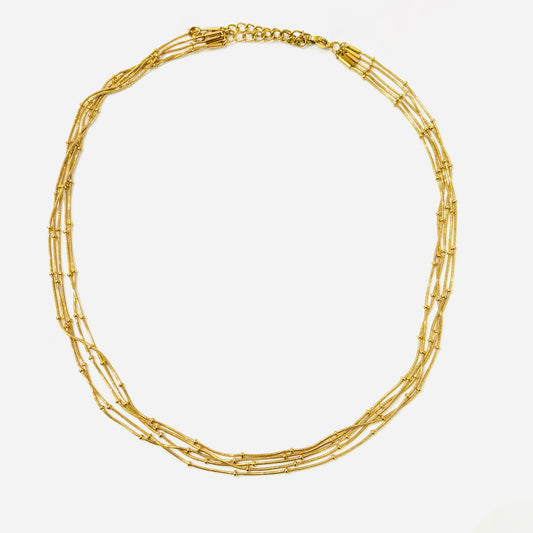 Collier multirangs acier inoxydable doré 
ajustable 
détails petites perles dorés 